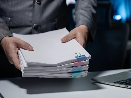 Employee holding private documents.