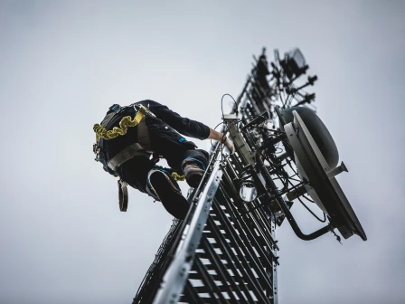 Telecom worker climbing an antenna tower