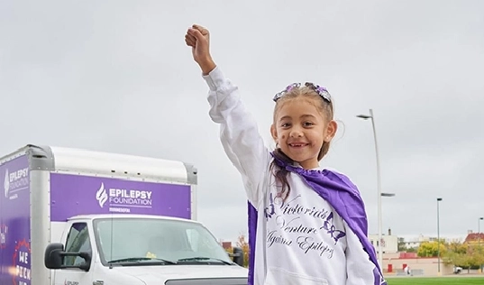 A child celebrating the success of the epilepsy foundation of minnesota