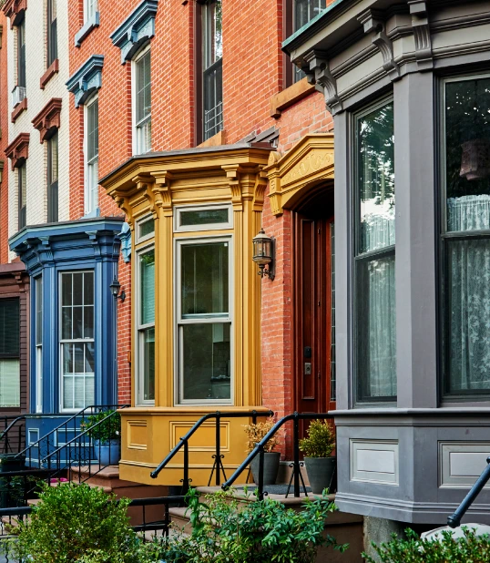 street view of an apartment complex with yellow, blue, and gray apartments