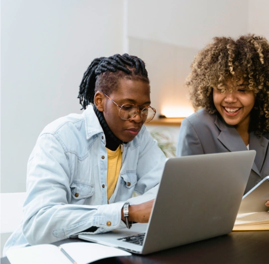 people looking at a laptop computer