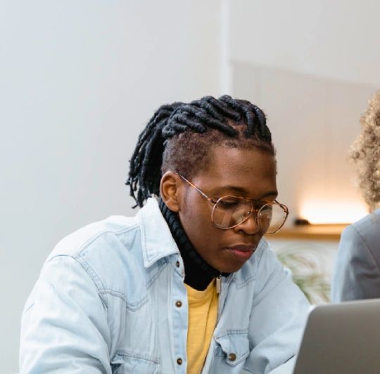 people looking at a laptop computer